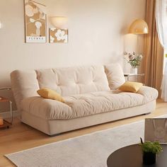 a living room filled with furniture and a white rug on top of a hard wood floor