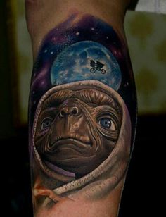 a man's leg with a tattoo on it and an image of a monkey wearing a space suit