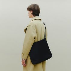 This functional high-density nylon bag features two compartments, including outer and internal zip pockets for optimal organization.  With an adjustable shoulder strap, it provides flexibility in terms of styling, allowing you to customize the fit and carry it in various ways.  The inclusion of triangle rings offers a functional feature for safely hanging accessories like AirPods. It also incorporates matt black-plated metal rings and sliders, adding a sleek touch to its design.  Finished with YKK® zippers, renowned for their quality and durability. Composition: Nylon 100% Care: Hand wash only, cold water Nylon Tote Shoulder Bag For Commuting, Nylon Commuting Shoulder Tote Bag, Commuting Tote Shoulder Bag With Adjustable Strap, Nylon Shoulder Bag With Removable Pouch For Commuting, Nylon Shoulder Satchel With Zipper Closure, Nylon Satchel With Zipper Closure, Nylon Satchel With Zipper Closure As Shoulder Bag, Nylon Bags With Zipper Pocket For Work, Nylon Work Bags With Zipper Pocket