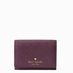 the kate spade card case in purple, with gold lettering on the front and side