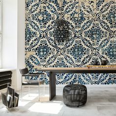 a blue and white patterned wall in a dining room