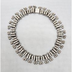 This is part of Chairish’s Costume Jewelry assortment.  Circa 1940s silvertone round medallions links with pairs of two bumps at the bottom collar necklace with fold over clasp. Marked "MONET." Measures: 5 3/4 inches long by 5 3/4 inches. Interior circumference is about 15 1/2 inches. Condition: Very good for its age, some tarnishing and wear. Nickel-free Round Costume Jewelry Necklace, Nickel-free Pendant Costume Jewelry, Vintage Silver Tarnish-resistant Necklaces, Monet Jewelry Vintage, Vintage Silver Hand-strung Beaded Necklace, Fold Over, Collar Necklace, Vintage Signs, Costume Jewelry