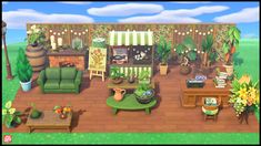 a living room filled with furniture and lots of potted plants on top of a wooden floor