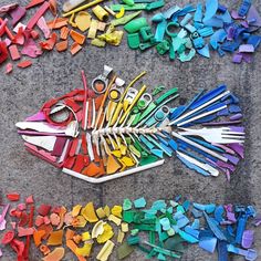 there are many different colored scissors on the ground next to each other and one is cut into smaller pieces