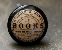 an old book's bottle cap sitting on the ground