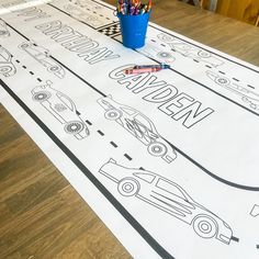 a table with cars and pencils on it