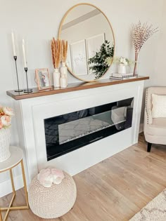 a living room with a white fireplace and mirror on the wall above it is decorated with flowers