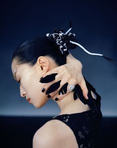 a woman with black and white nail art on her face