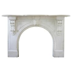 an old white fireplace mantel with carvings on the front and sides, isolated against a white background