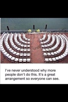 an empty auditorium with rows of white chairs