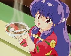 a woman holding a plate with sushi on it