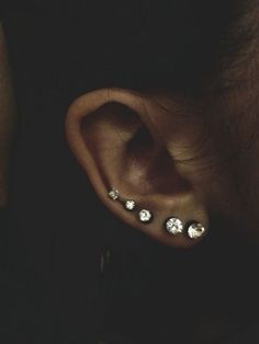 a person with some piercings on their ear