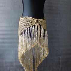 Tribal belly dance hip scarf is an exquisite and versatile accessory designed to elevate your dance and performance attire.   This sparkle lace fringe belt not only for dance, you can wear this hip shawl over leggings, jeans, or over long skirt. it can be original dance teacher gift or the finishing touch for a exotic dance wear or Bohemian clothes Hip wrap made from the viscose polyester blended yarn in beige -silver colors *Crochet fringe skirt has length including fringes -25,2" (64cm) Width Crochet Belly Dance Skirt, Belly Dance Stretch Skirt For Festivals, Belly Dance Festival Stretch Skirt, Belly Dancing Hip Scarf, Festival Belly Dance Fitted Skirt, Fringe Belt, Belly Dance Hip Scarf, Hip Scarf, Exotic Dance