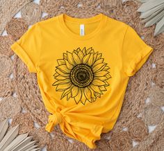 Sunflower Shirt, Sunflower T-Shirt Floral Tee Shirt Flower Shirt Garden Shirt Womens Fall Shirt Sunflower Tshirt Sunflower Shirts Sunshine This unisex t-shirt fits like a well-loved favorite. It has a soft and light feel, with just the right amount of stretch. * Made of combed and ring-spun cotton * Comfortable and flattering for both men and women SIZING * See sizing chart illustration. * If unsure as to what size to order, lay a favorite t-shirt flat and measure from armpit to armpit (width) a Sunflower T Shirt Design, Yellow Short Sleeve Top With Sublimation Print, Cotton Crew Neck T-shirt With Sunflower Design, Cotton Short Sleeve T-shirt With Sunflower Print, Yellow Cotton Shirt With Sublimation Print, Sunflower Tshirt Designs, Yellow Sublimation Print Top For Summer, Yellow Summer Top With Sublimation Print, Yellow Graphic Tee With Floral Print