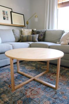 a living room with a couch, coffee table and rug