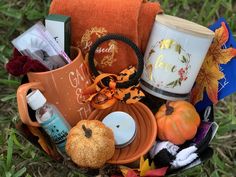 a basket filled with lots of different items on top of a grass covered field next to trees