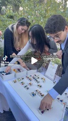 a group of people standing around a table with legos on it