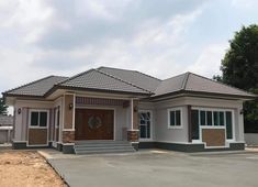 a two story house with a brown front door