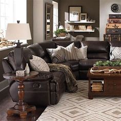 a living room filled with lots of furniture and decor on top of a wooden floor