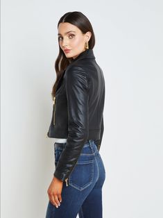 A cropped biker jacket in luxe black leather. Clean, fitted design with gleaming gold zipper and zippered pockets. Silhouette tapers from shoulder to cropped waist for flattering definition. Front zipper closure. Fully lined. 100% Leather. | L'AGENCE Onna Leather Jacket In Black Cropped Biker Jacket, Leather Jacket Black, Black Handle, Gold Zipper, Fall Collections, Biker Jacket, Front Zipper, New Product, Blazer Jacket