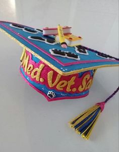 a decorated graduation cap with the words med vets on it and a tassel