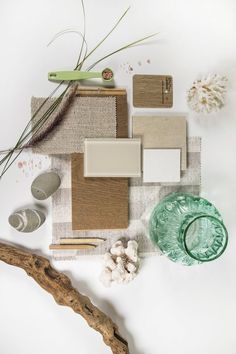 various items are arranged on a white surface including glass, wood, and other materials