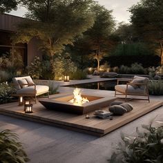 an outdoor fire pit surrounded by plants and trees at night with lit candles on the ground