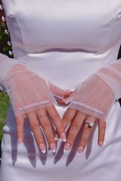 a woman in white dress holding her hands together