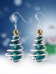 the christmas tree earrings are made with swarong wire and green crystal stone beads