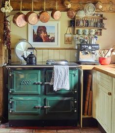 an old fashioned green stove in a kitchen