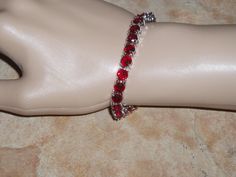 "Beautiful Red 133.00 Carats of Brazilian Red Ruby 6mm Round Cut Gemstones,18K White Gold Filled 7 1/2\" Inch Tennis Bracelet. FREE SHIPPING in the USA, $11 Everywhere else, it costs me $14.83 to ship to other countries, so I have to recover some of this cost. **Matching Earrings in Earring Section of Shop. **The Gemstones are from the Upper Crust of the mine and are not as good a quality as the gemstones deeper down, they have not has as many million years of earth's pressure to be the very bes Red Round Tennis Bracelet For Formal Occasions, Red Ruby Gemstone Tennis Bracelet, Red Ruby Jubilee Tennis Bracelet, Red Gemstone Tennis Bracelet For Anniversary, Anniversary Red Gemstone Tennis Bracelet, Red Tennis Bracelet Gift, Red Jubilee Tennis Bracelet For Anniversary, Silver 925 Necklace, Ruby Gemstone