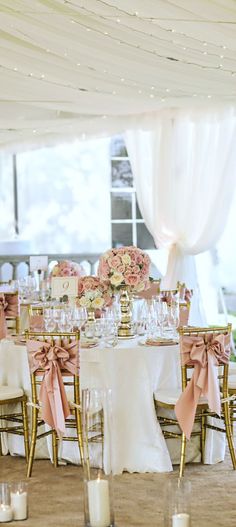 the tables are decorated with pink and white flowers