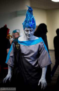 a man with blue hair is dressed in costume