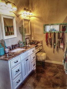 a bathroom with two sinks, mirrors and towels hanging on the rack in it's corner