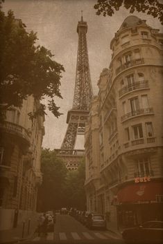 the eiffel tower in paris, france is seen from an old street corner