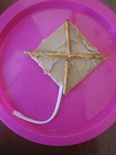 a pink plate with a piece of food on it