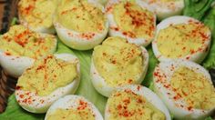 several deviled eggs are arranged on lettuce