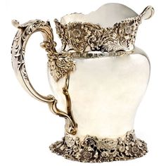 an ornately decorated white vase with gold trimmings