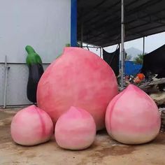 three giant pink balls sitting next to each other