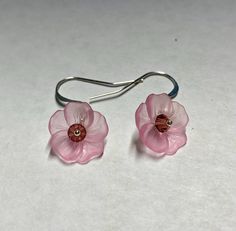 Nature inspired light pink sweet pansy flower earrings with yellow Swarovski crystal center and silver plated surgical steel hammered French hook ear wires.  Earrings measure about 1 inch in length. Questions? please message me. Thanks for visiting my shop. View all Southpass Beads and Fibers beads, yarn and supplies here: http://www.etsy.com/shop/southpassbeads Thanks for visiting my shop! Please come back again! Nickel-free Pink Flower-shaped Jewelry, Nickel-free Round Pink Flower Earrings, Round Pink Nickel-free Flower Earrings, Delicate Nickel-free Pink Earrings, Nickel-free Czech Glass Flower Earrings, Adjustable Nickel-free Flower Earrings, Pink Sterling Silver Flower Earrings, Pink Flower Earrings With Adjustable Ear Wire, Adjustable Pink Flower-shaped Jewelry