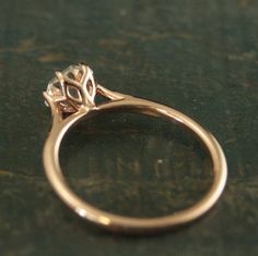 a close up view of a gold ring with a diamond on it's side