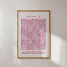 a pink and white poster hanging on the wall