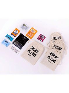 various stickers, tags and bags on a white surface with the words drink in love