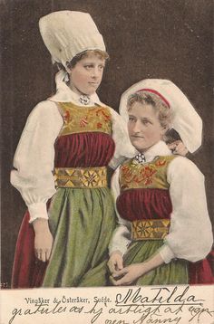 two women in traditional dress standing next to each other