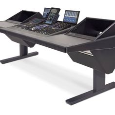 a laptop computer sitting on top of a desk next to a sound mixing console with two monitors