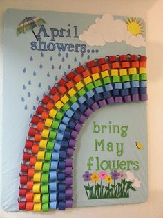 a rainbow made out of legos sitting on top of a white board with the words, spring showers bring may flowers