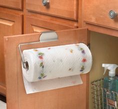 a roll of toilet paper hanging from a cabinet