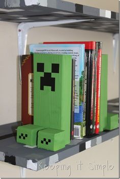 a book shelf filled with books and a green toy