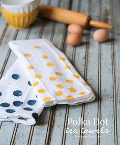 a polka dot tea towel sitting on top of a wooden table next to an egg roller