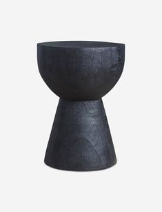 a black vase sitting on top of a table